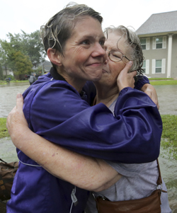 Amanda Ankney hugs her mother Sharon Gilleon after both her parents were rescued from their home during Tropical Storm Harvey, Monday, Aug. 28, 2017, in Houston. (Godofredo A. Vasquez/Houston Chronicle via AP)